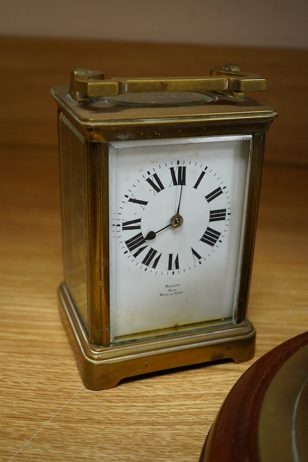 A brass bulk head timepiece and a late 19th century brass cased carriage clock, the dial inscribed Mallory Bath, made in Paris, with key